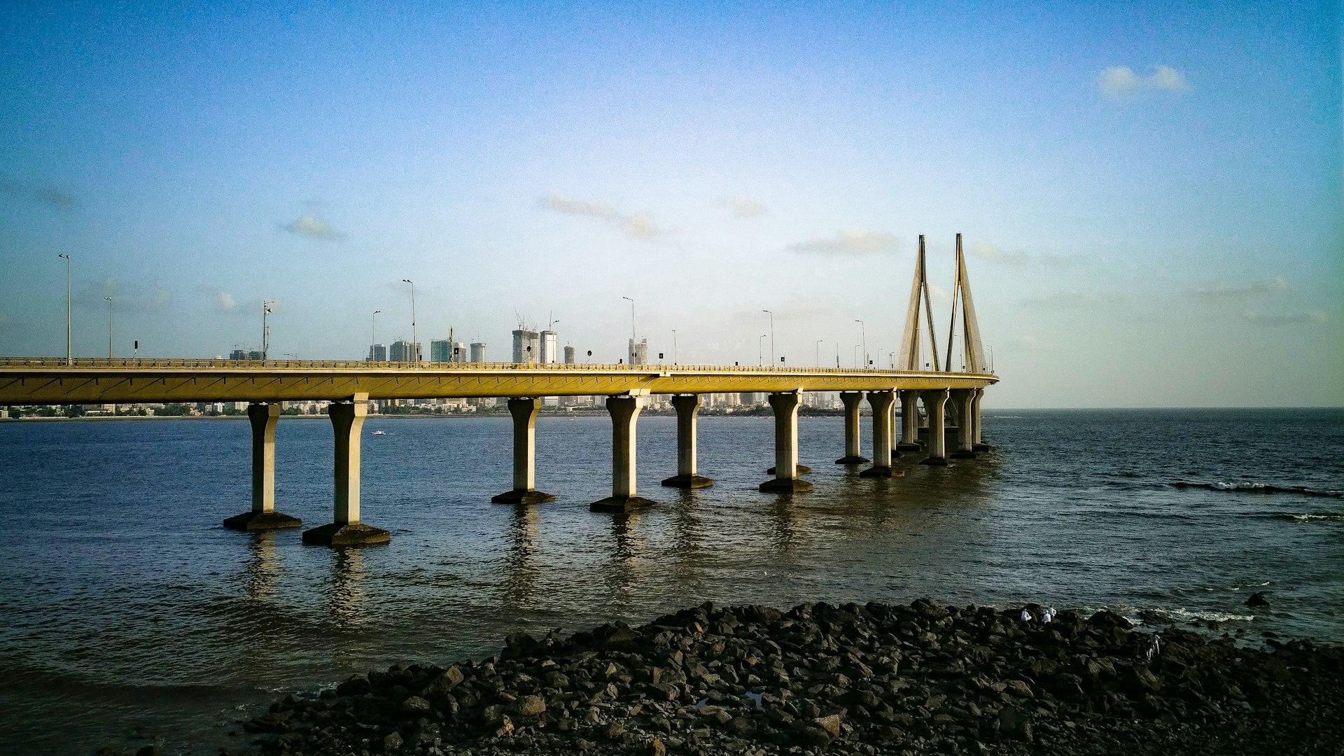 white concrete bridge over the sea during daytime